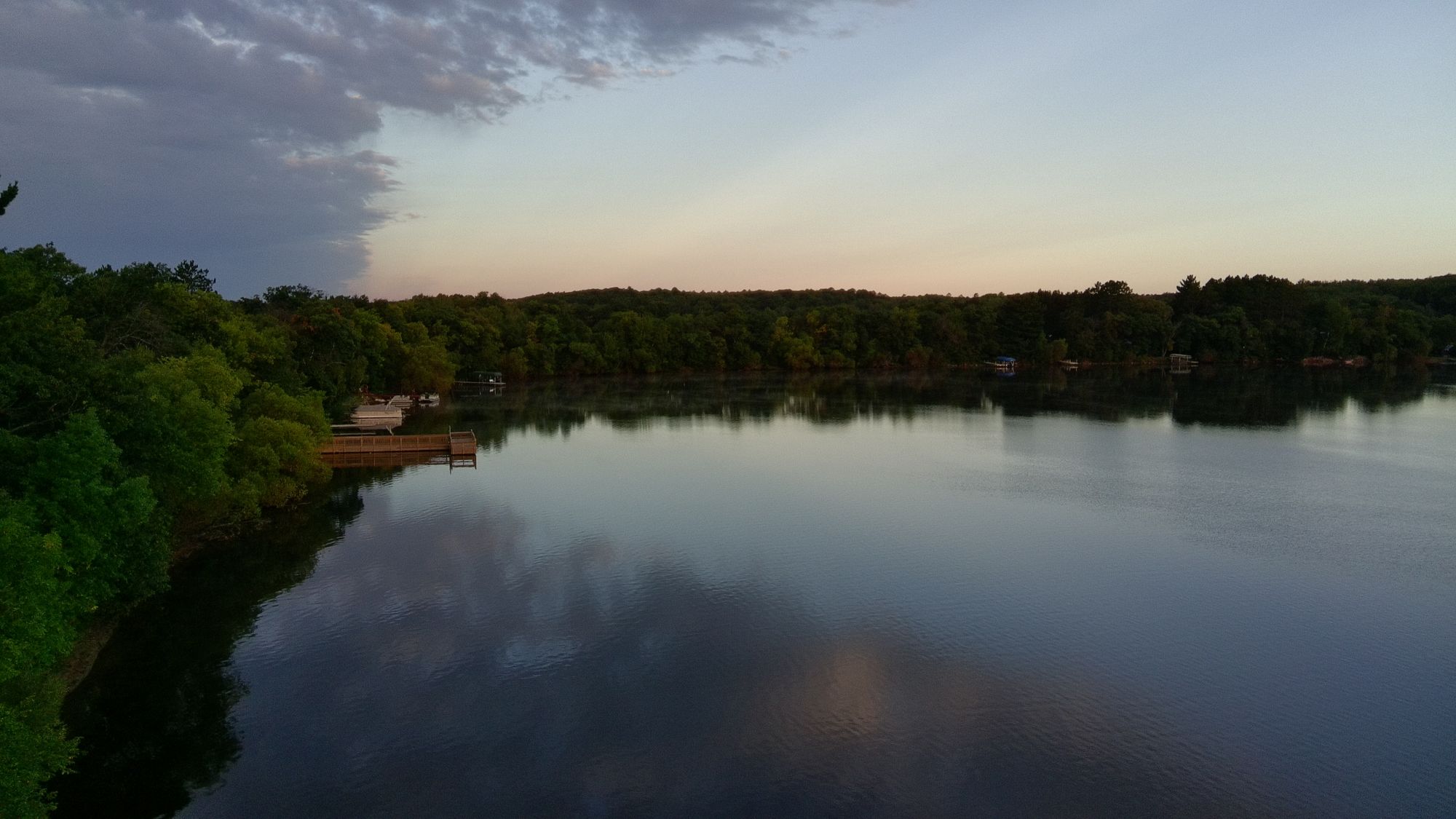 Aerial of a calm lake shoreline at dusk